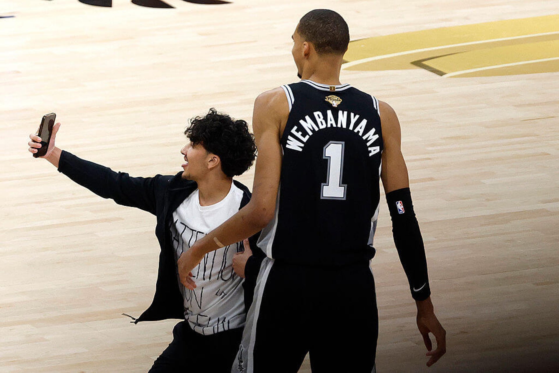 Fan Takes Court for Selfie with Victor Wembanyama During NBA Finals